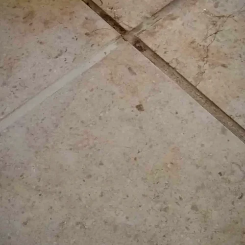 Floor tiles with dark, stained grout lines